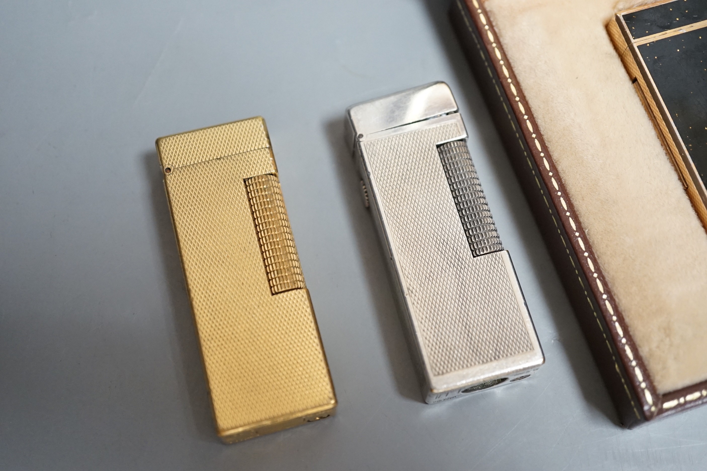 Three Dunhill lighters, one boxed